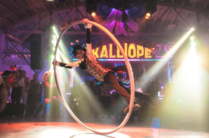 Shawn performing on a cyr wheel under stage lights