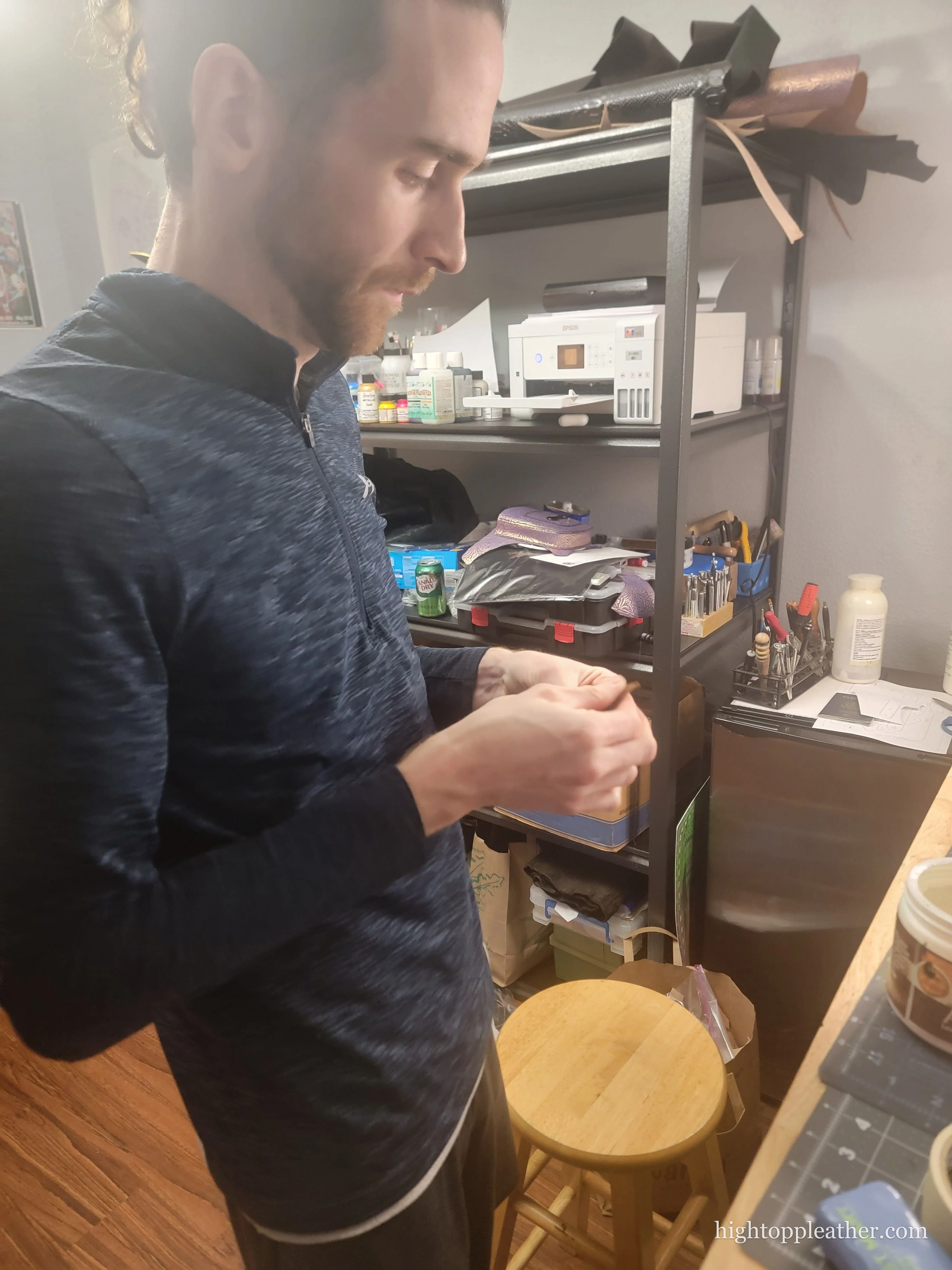 Shawn at his workbench, mid-stitch